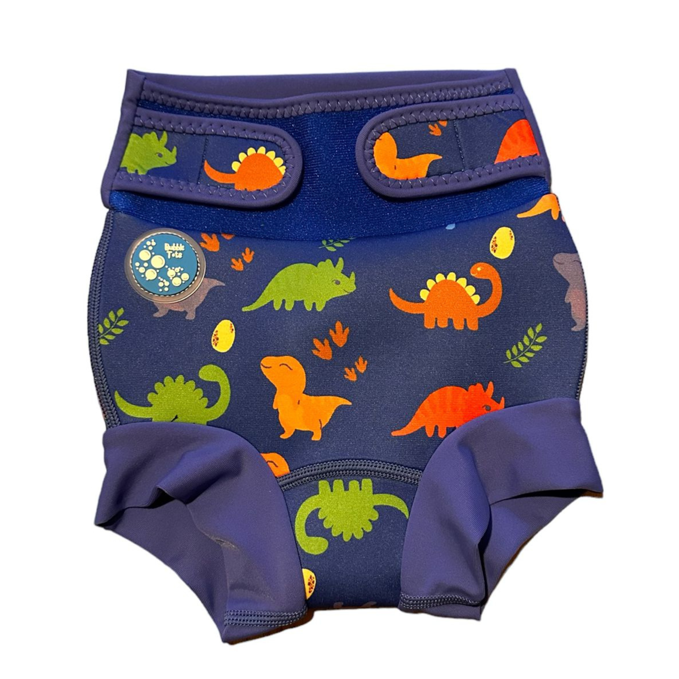 Bubble Tots Go Anywhere Swim Nappy Blue Dinosaurs Design An image of the Bubble Tots Go Anywhere Swim Nappy in Blue Dinosaurs design. The design features playful Dinosaurs, Eggs and Prints.
