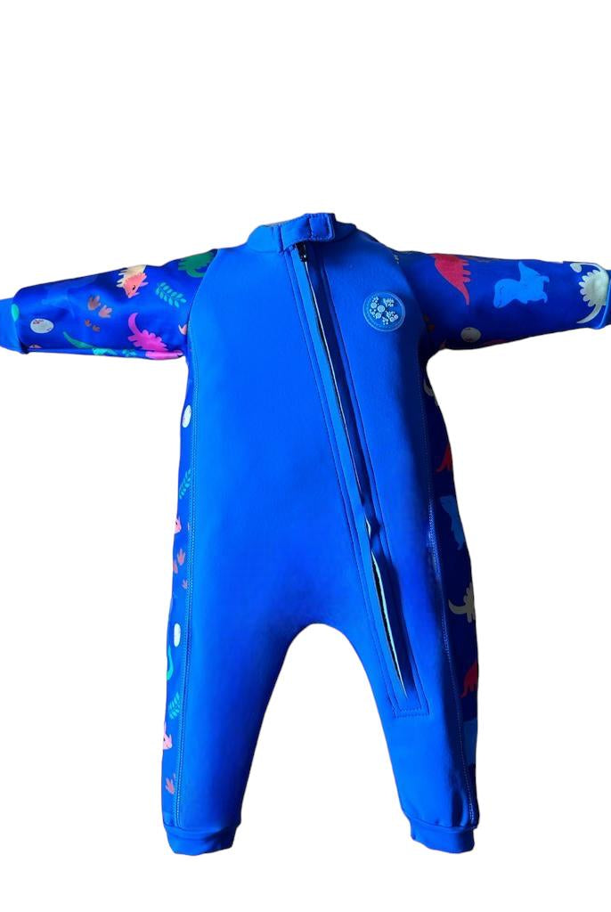An image of the Bubble Tots Easy Zip Thermal Swimsuit in Blue Dinosaur design. The design features playful Dinosaurs and Eggs. The background colour is a bright vibrant tone with pops of vibrant Dinosaur illustrations