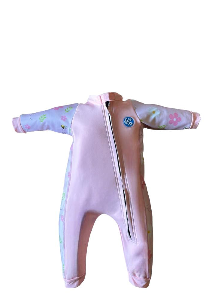 An image of the Bubble Tots Easy Zip Thermal Swimsuit in Pink Flowers and Bees Spring design. The design features playful Bees and Flowers. The background colour is a soothing neutral pink tone with pops of vibrant Flowers and Bees illustrations