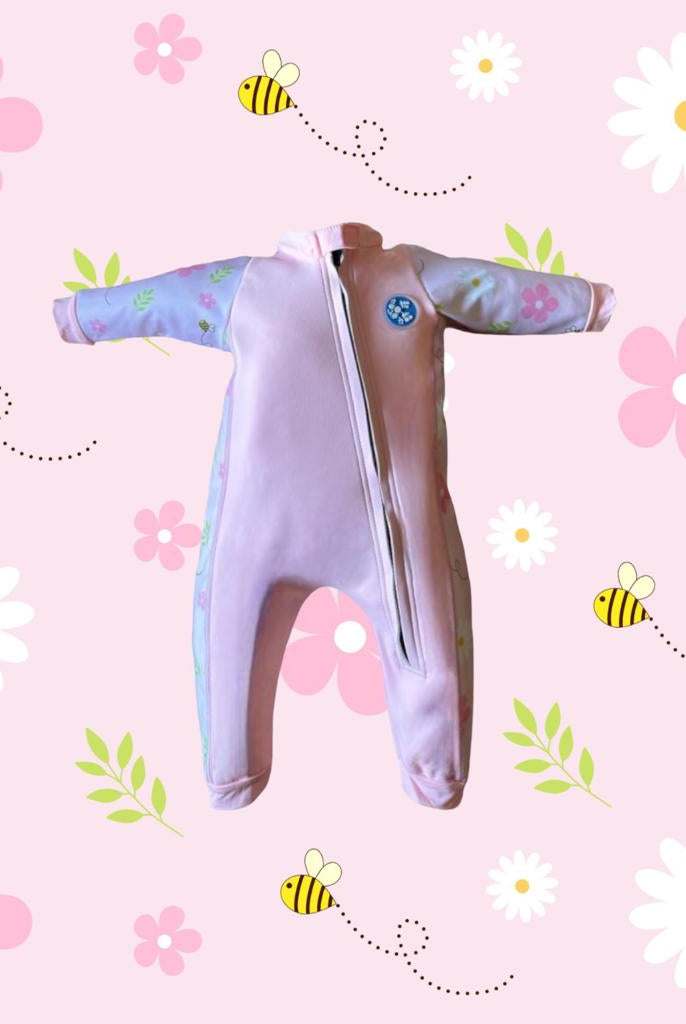 An image of the Bubble Tots Easy Zip Thermal Swimsuit in Pink Flowers and Bees Spring design. The design features playful Bees and Flowers. The background colour is a soothing neutral pink tone with pops of vibrant Flowers and Bees illustrations
