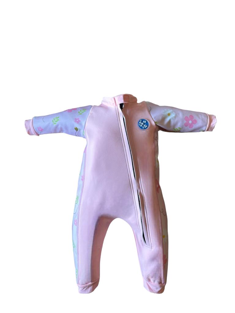 An image of the Bubble Tots Easy Zip Thermal Swimsuit in Pink Flowers and Bees Spring design. The design features playful Bees and Flowers. The background colour is a soothing neutral pink tone with pops of vibrant Flowers and Bees illustrations